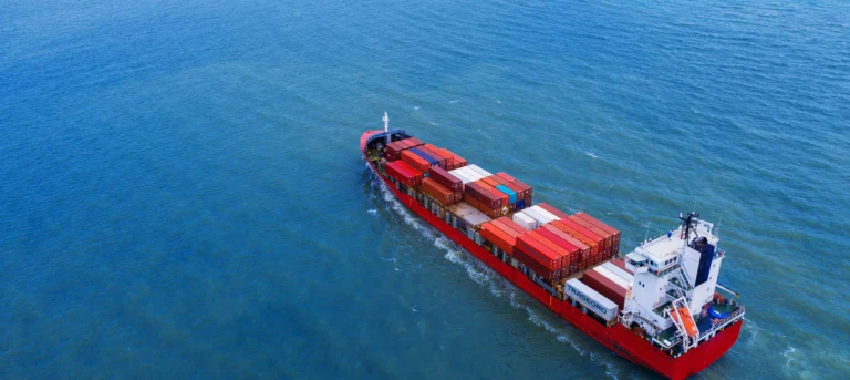Cargo ship transporting Trasegro containers across the ocean.